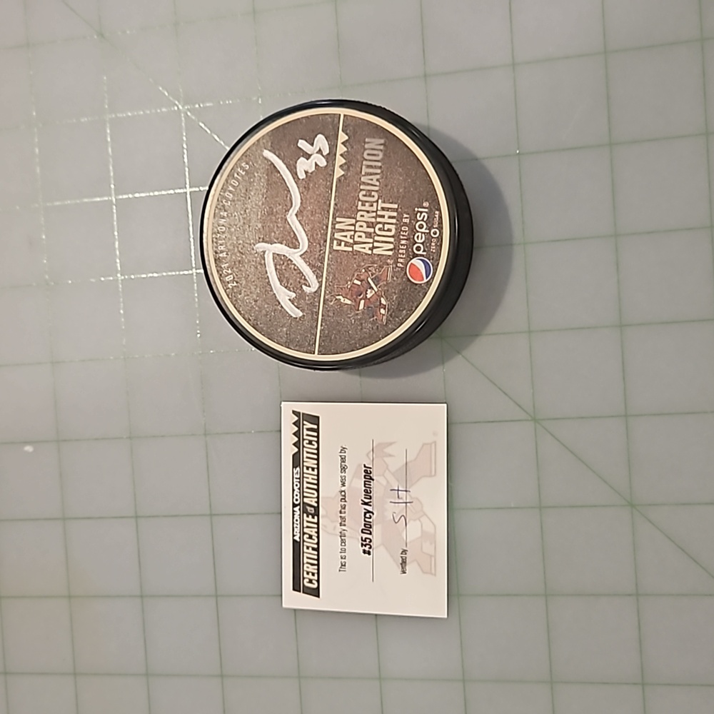 Coyotes hockey puck, certified and signed by Darcy Kuemper